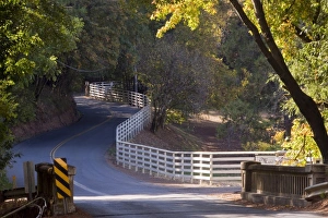 White fence curves alongside Westside Road, Sonoma, California, USA White fence curves alongside Westside Road, Sonoma, California, USA