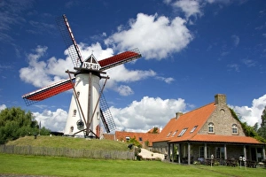 A windmill and old stone restaurant in the town of Ramskapelle in the municipality A windmill and old stone restaurant in the town of Ramskapelle in the municipality
