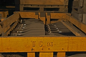 In the wine cellar: Dusty dust covered bottles lying in a wooden crate after the In the wine cellar: Dusty dust covered bottles lying in a wooden crate after the