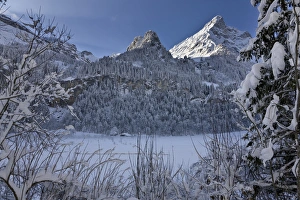 Winter landscape at Tschingelsee (lake Tschingel) in Kiental, Bernese Alps, with mornig fog Winter landscape at Tschingelsee (lake Tschingel) in Kiental, Bernese Alps, with mornig fog