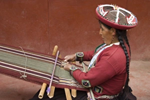 Woman in traditional dress and hat weaving using a backstrap loom to weave, Chinchero Woman in traditional dress and hat weaving using a backstrap loom to weave, Chinchero
