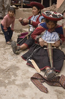Women in traditional dress and hat weaving using a backstrap loom to weave, Chinchero Women in traditional dress and hat weaving using a backstrap loom to weave, Chinchero