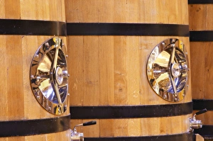 Detail of wooden fermentation tanks vats with a polished stainless steel door Detail of wooden fermentation tanks vats with a polished stainless steel door