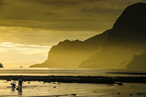 Young boys fishing at sunset in the bay of El Nido, Bacuit Archipelago, Palawan Young boys fishing at sunset in the bay of El Nido, Bacuit Archipelago, Palawan
