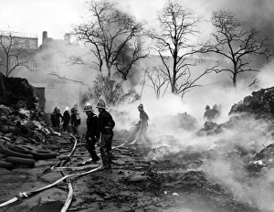 Firefighters in action with hosepipes, Poplar, East London Firefighters in action with hosepipes, Poplar, East London