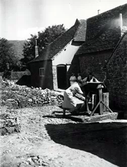 Images Dated 1st August 2013: Two people using a well on a farm at Upperton, Sussex, August 1936