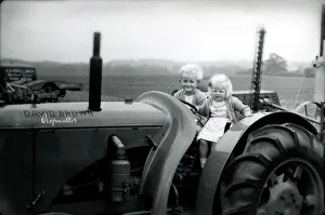 Two small children on a tractor, 1949 Two small children on a tractor, 1949