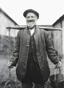 Farm worker with buckets on a yoke, Lavant, Sussex Print