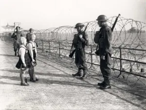 Prints of On the Esplanade at Bognor Regis. Talking to soldiers of the Bedfordshire and Hertfordshire Light Infantry, then on coastal defence duties at Bognor. Pamela is carrying a bucket and spade Bedfordshire Prints: Print of two sisters on the Esplanade at Bognor Regis