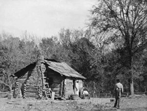 ALABAMA: LOG CABIN, c1890. Three African Americans outside a log cabin in Mt. Meigs, Alabama