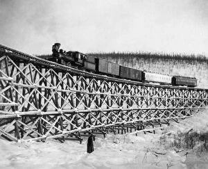 Images Dated 31st March 2011: ALASKA: RAILROAD, 1916. Railroad train as it crosses the Fox Gulch bridge, Alaska. Photograph, 1916