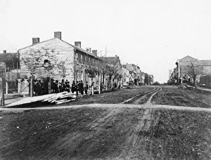 AMERICAN TOWN. Group of well-dressed men standing near an empty lot in an American town AMERICAN TOWN. Group of well-dressed men standing near an empty lot in an American town