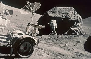 APOLLO 17, DECEMBER 1972: Front of Lunar Rover and Schmitt working by large boulder