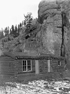 ARIZONA: LOG CABIN, c1908. Log cabin with a thatched roof in front of a large rock