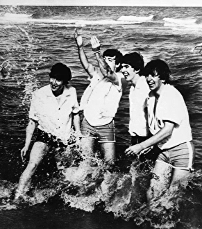 THE BEATLES, 1964. The Beatles playing in Lake Erie during a trip to Cleveland, Ohio THE BEATLES, 1964. The Beatles playing in Lake Erie during a trip to Cleveland, Ohio