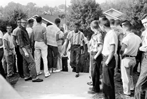 A black student walking through a crowd of white boys in Clinton, Tennessee