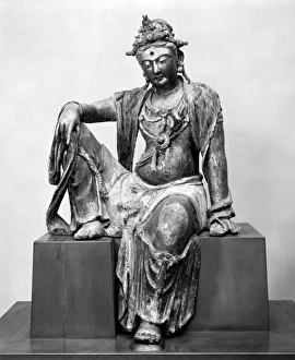 The bodhisattva Guanyin in the royal ease position. Painted, lacquered, and gilded wood The bodhisattva Guanyin in the royal ease position. Painted, lacquered, and gilded wood