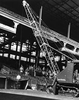 BROOKLYN: EBBETS FIELD. A crane with a wrecking ball on top of the visitors dugout at Ebbets Field in Brooklyn