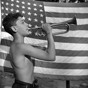 BUGLER, 1943. A camper playing mess call on a bugle at Camp Nathan Hale, an interracial BUGLER, 1943. A camper playing mess call on a bugle at Camp Nathan Hale, an interracial