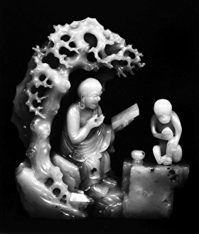 Carved jade figure of a lohan and a monkey in a grotto. Ching Dynasty, late 17th century Carved jade figure of a lohan and a monkey in a grotto. Ching Dynasty, late 17th century