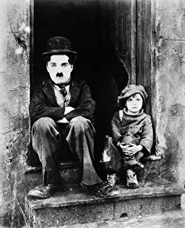 CHAPLIN: THE KID, 1921. Charlie Chaplin and Jackie Coogan as his adopted son in Chaplins film The Kid, 1921