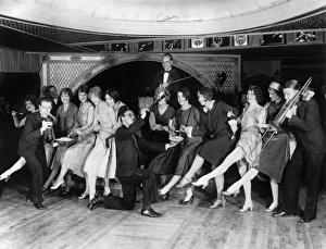 Contestants at a Charleston dance contest being served food by musicians at a nightclub Contestants at a Charleston dance contest being served food by musicians at a nightclub