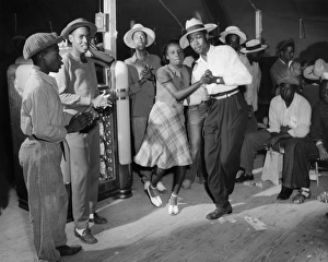 A dance in the recreation tent at a Farm Security Administration workers camp in A dance in the recreation tent at a Farm Security Administration workers camp in