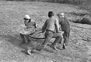 Farm children playing on a homemade merry-go-round. Photograph, 1937, by Russell Lee Farm children playing on a homemade merry-go-round. Photograph, 1937, by Russell Lee