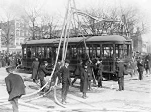 FIREMEN, c1918. Firemen with hoses over a street car, United States. Photograph, c1918 FIREMEN, c1918. Firemen with hoses over a street car, United States. Photograph, c1918