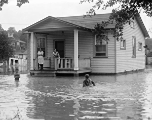 FLOOD, 1922. Children on the porch of a flooded house. Photograph, 2 September 1922 FLOOD, 1922. Children on the porch of a flooded house. Photograph, 2 September 1922