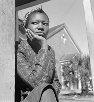 Gordon Parks Gallery: FLORIDA: WOMAN, 1943. A young woman sitting on her porch on Sunday morning in Daytona Beach