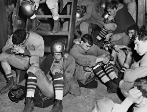 FOOTBALL, 1950. A dejected high school football team in their locker room in Freeport FOOTBALL, 1950. A dejected high school football team in their locker room in Freeport