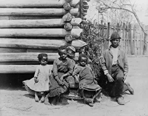 GEORGIA: CHILDREN, c1886. A group of African American children outside a log building