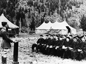 A group of Civilian Conservation Corps workers wearing caps and gowns and listening A group of Civilian Conservation Corps workers wearing caps and gowns and listening