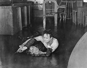 HARRY HOUDINI (1874-1926). American magician. Houdini overpowers Eugene Pallette in Terror Island, 1920