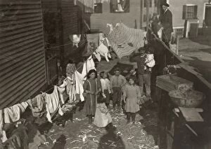 Architecture Collection: HINE: MILL HOUSING, 1912. Textile mill workers family in the yard with a clothesline