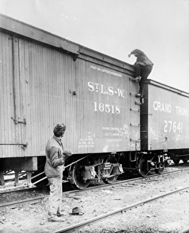 HOBOS, c1915. A hobo climbing on top of a railroad car. Photograph, c1915 HOBOS, c1915. A hobo climbing on top of a railroad car. Photograph, c1915