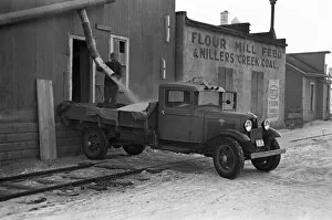 Pick Up Truck Gallery: IOWA: CORN MILL, 1936. Loading corn kernels onto a truck from an elevator shoot, Spencer, Iowa