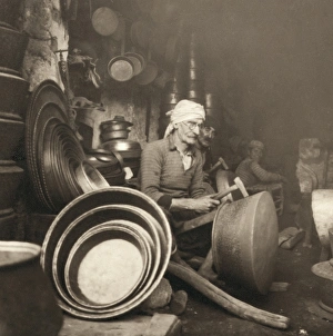 ISRAEL: METAL WORKERS, 1938. Coppersmith at Nazareth, Israel, hammering out a dist ISRAEL: METAL WORKERS, 1938. Coppersmith at Nazareth, Israel, hammering out a dist