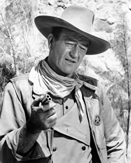 JOHN WAYNE (1907-1979). American actor. Wayne in a scene from The Comancheros JOHN WAYNE (1907-1979). American actor. Wayne in a scene from The Comancheros