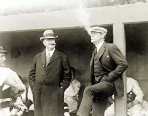 JOHNSON & RUTH, 1922. American baseball executive Ban Johnson (left) smoking cigars at a baseball game in Washington, D