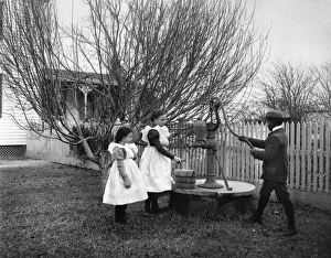 JOHNSTON: HAMPTON CHILDREN. Three children of Hampton, Virginia, playing with a JOHNSTON: HAMPTON CHILDREN. Three children of Hampton, Virginia, playing with a