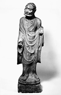 A lohan holding prayer beads in one hand, with the other raised in a preaching gesture A lohan holding prayer beads in one hand, with the other raised in a preaching gesture