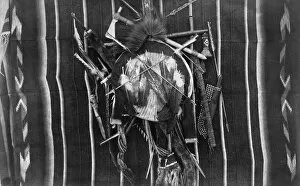 NATIVE AMERICAN SHIELD. Kiowa of Comanche shield adorned with feathers, with tomahawks