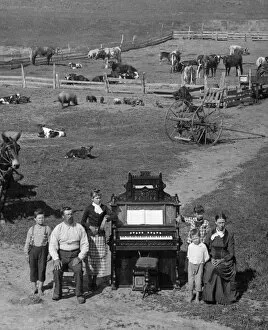 Images Dated 29th December 2010: NEBRASKA: FRONTIER FAMILY. The family of David Hilton posing next to their organ on their farm