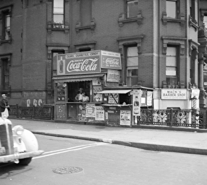 NEW YORK CITY, 1938. A newsstand on the street in Harlem, New York City NEW YORK CITY, 1938. A newsstand on the street in Harlem, New York City