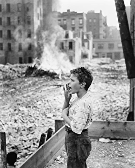 NEW YORK: SLUM, 1961. A boy yelling, backed by the remnants of a demolished slum NEW YORK: SLUM, 1961. A boy yelling, backed by the remnants of a demolished slum