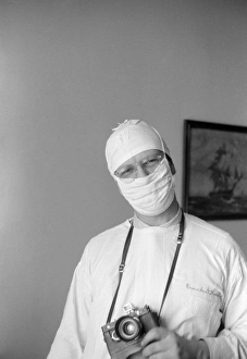 PHOTOGRAPHER, 1941. A photographer, probably Edwin Rosskam, wearing a surgical PHOTOGRAPHER, 1941. A photographer, probably Edwin Rosskam, wearing a surgical