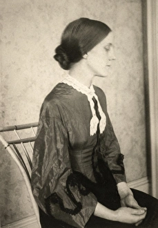 PORTRAIT OF A WOMAN, c1895. A woman in a dark dress, seated in a bamoo-backed chair PORTRAIT OF A WOMAN, c1895. A woman in a dark dress, seated in a bamoo-backed chair