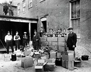 Liquor Gallery: PROHIBITION, 1922. Revenue agents with confiscated bootleg liquor at Washington, D.C. Oct. 14, 1922